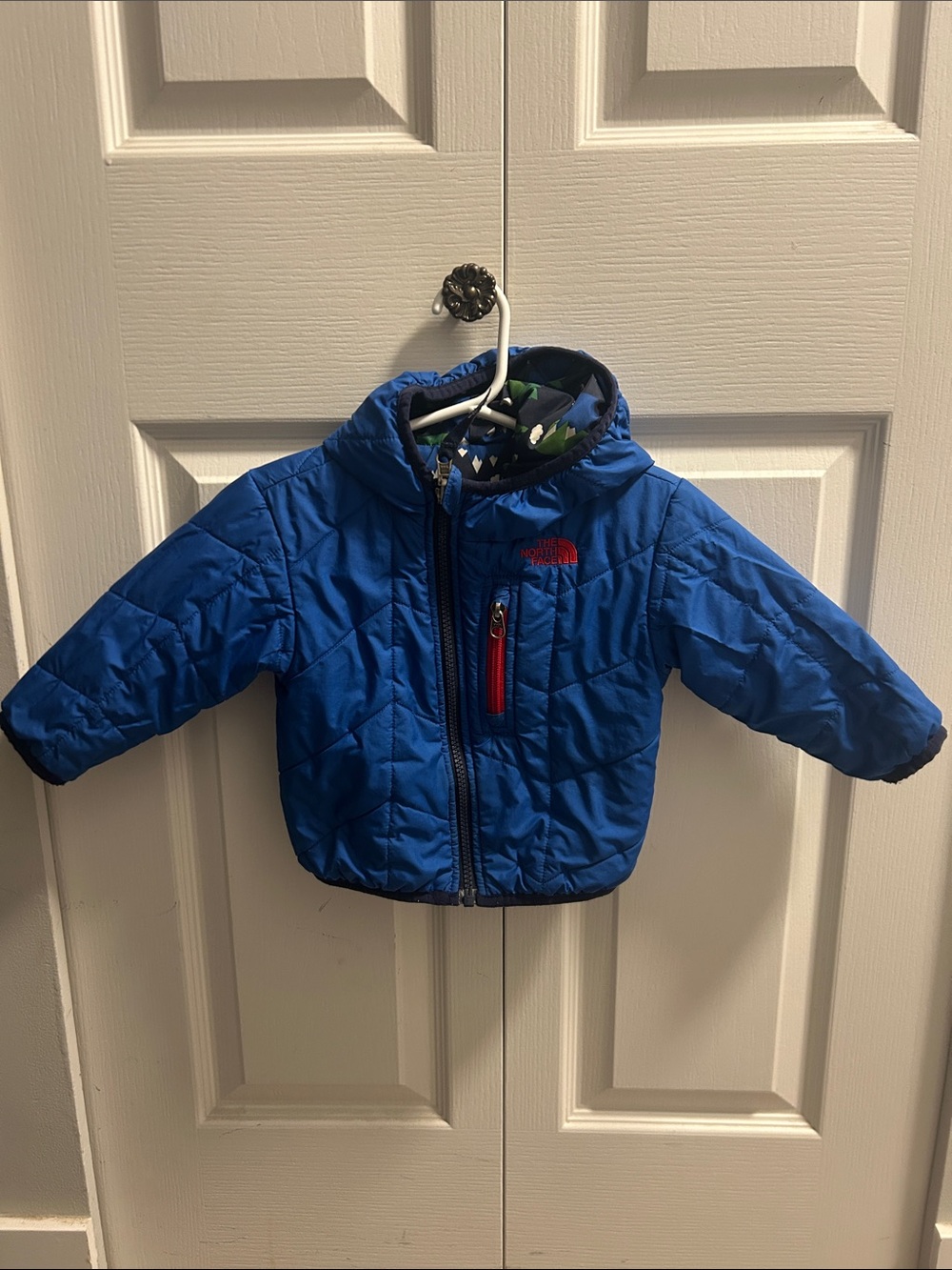The North Face Kids Blue Hooded Puffer Jacket with Red Zip Accent